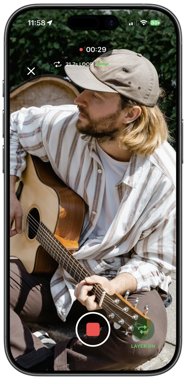 A guitarist recording outdoors with live audio layering in Ampfold